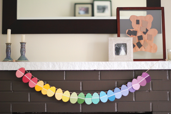 An easy upcycled Easter garland using paint chips - LOVE the pretty colors and how the lines on the paint chips mimic the lines in plastic Easter eggs.
